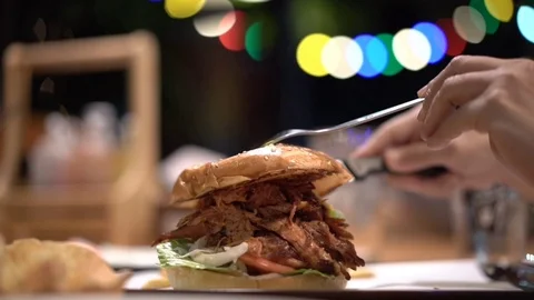 Pulled pork burger on dinner table with beautiful light bokeh Stock Footage 109371203