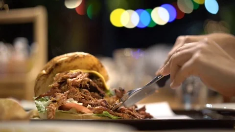 Pulled pork burger on dinner table with beautiful light bokeh Stock Footage 109371212