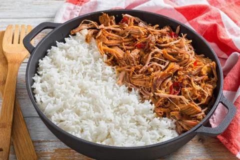 Pulled  pork with long-grain basmati rice in iron stewpot Stock Photos