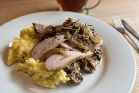 Pulled pork with mashed potato and mushroom sauce meal on white plate Stock Photos
