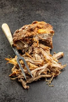 Pulled pork meat with fork Pulled pork meat with fork on black table. Copy... Stock Photos
