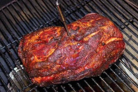 Pulled pork roast on barbecue grill with meat thermometer Stock Photos