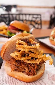Pulled pork sandwich with crispy fried onion rings Stock Photos