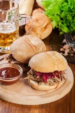 Pulled pork sandwich with red cabbage and bbq sauce on cutting board Stock Photos