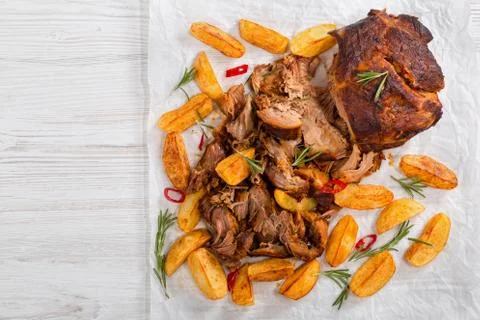Pulled slow-cooked pork grilled in oven with fried potato Stock Photos