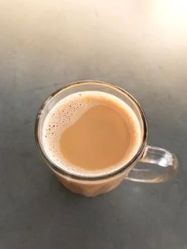 Pulled tea or milk tea (“teh tarik”) is favorite Malaysian breakfast. Stock Photos