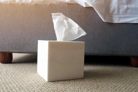 Pulled tissue paper box bedside bed in the bedroom Stock Photos