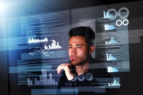 Pulling an all nighter. a focussed computer programmer working at his computer 스톡 사진