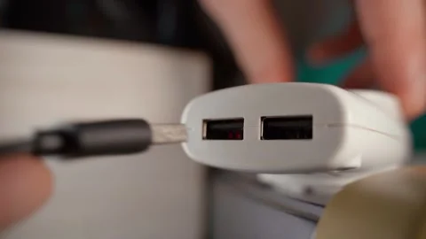 Pulling and inserting a USB cable into an adapter for a socket, close-up Stock Footage 324517603
