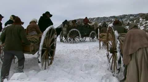 Pulling and pushing handcarts over winter prairie Video stock 11365371