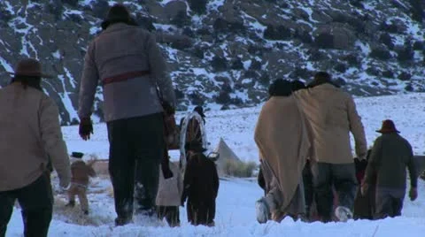 Pulling and pushing handcarts over winter prairie Stock Footage 11365477