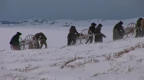 Pulling and pushing handcarts over winter prairie Video stock 11365643
