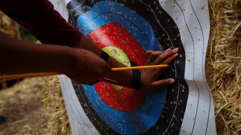 Pulling Arrow out of Archery Target Stock Footage