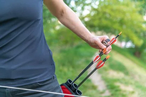 Pulling an arrow out of the holster at archery races Stock Photos