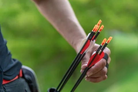 Pulling an arrow out of the holster at archery races Stock Photos