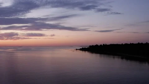 Pulling Away From Coast at Sunrise over Great Lake Aerial. Depart land, rising Stock Footage 137657540
