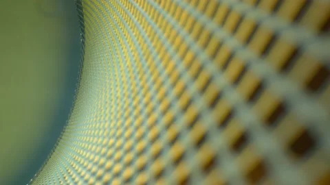 Pulling away from a macro view of a curved metal grid. DEFOCUSED portions Stock Footage 162447402