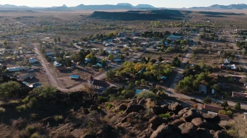 Pulling away to reveal mountaintop overlooking rural Texas Town at Sunrise Stock Footage 298206676
