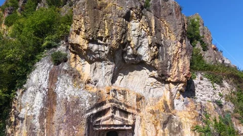 Pulling Back from Ancient Rock Tombs with Birds Flying Past Video stock 340472150