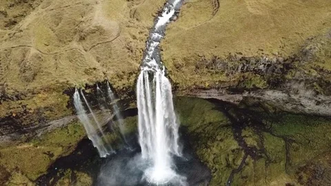 A pulling back and panning up shot of Seljalandfoss waterfall Iceland Stock Footage 109589814