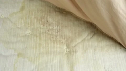 Pulling Back A Bedsheet To Reveal A Urine Stained Mattress Stock Footage
