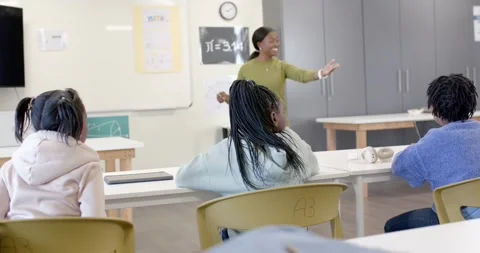Pulling back from blue backpack pencil, African teacher leading math in class, Stock Footage 341028368
