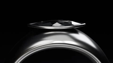 Pulling back camera revealing metal ring on black plinth, showing faceted top, Stock Footage 339194293