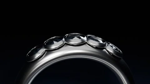 Pulling back camera revealing polished ring with faceted gems, showing full Stock Footage 339194336