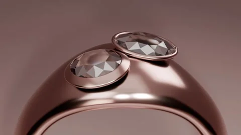 Pulling back camera revealing rose-gold ring with two faceted gems in studio, Stock Footage 339194333