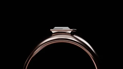 Pulling back camera revealing rosegold ring, faceted top in studio, light sweep Stock Footage 339194339