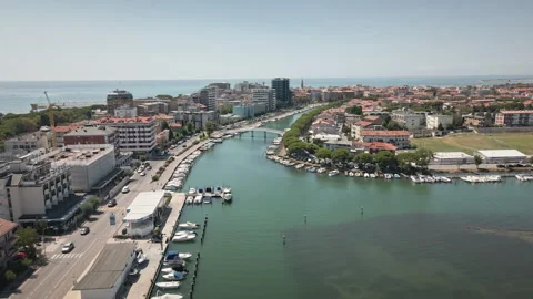 Pulling back drone aerial from Grado town canal and bridge in the afternoon 4K 動画素材 331349343