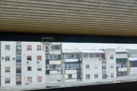 Pulling up a blind in an apartment Stock Photos