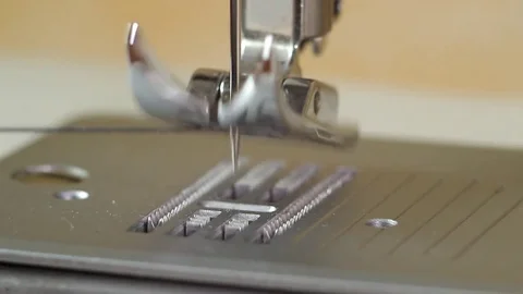 Pulling the bottom thread through the needle plate of the sewing machine Stock Footage 82354669