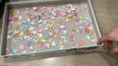 Pulling a box with puzzle pieces Stock Footage 240644929
