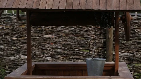 Pulling a bucket full of water from the well. Stock Footage 127526529