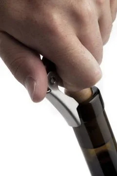 Pulling cork out of wine bottle Stock Photos