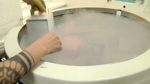 Pulling from a deep cryopreservation of biological samples Stock-Footage 103554476