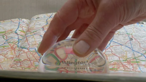 Pulling a dome magnifier across a map of London heading eastwards. Video stock 140123601