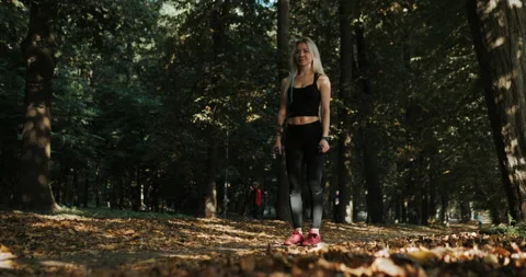Pulling dumbbells while standing. Morning workout at park	 Stock Footage 139878359