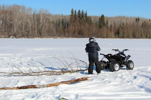 Pulling Firewood With a Quad to Make a Fire on the Ice Stock Photos