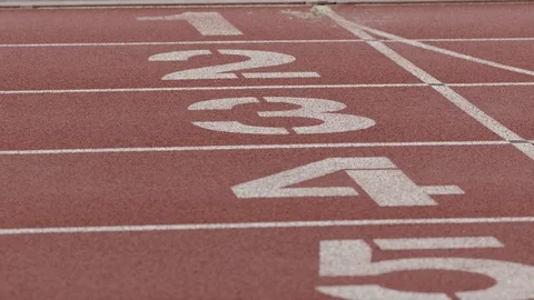 Pulling focus on lane numbers on a track Stock Footage 106590232