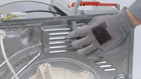 Pulling a grey tube through a hole Stock Footage