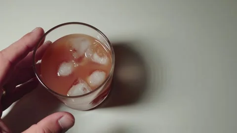 Pulling hand away from cocktail slowly Stock Footage 318773632