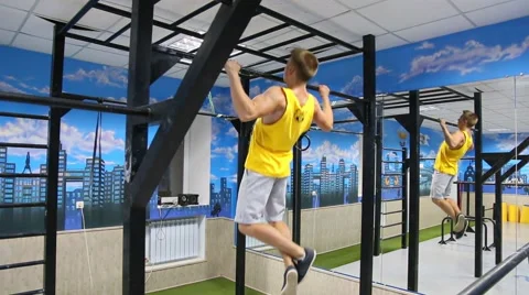 Pulling up on a horizontal bar in the gym Stock Footage 58208243