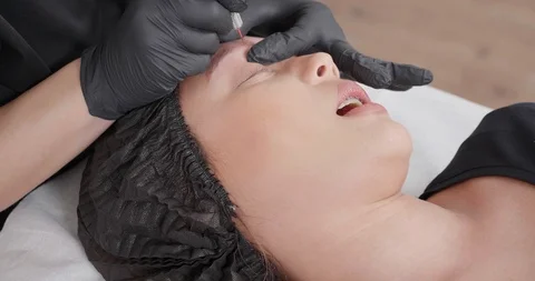 Pulling the ink out of the eyebrow tattoo Stock Footage 103793415