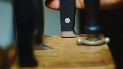 Pulling A Knife From The Wood Stand Knife Holder In The Kitchen - closeup Stock Footage 130481109