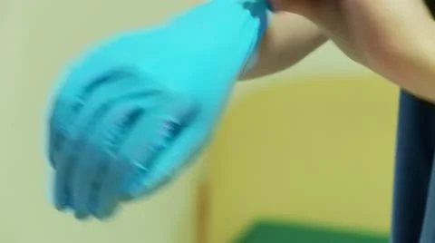 Pulling on latex gloves close up Stock Footage 10869732