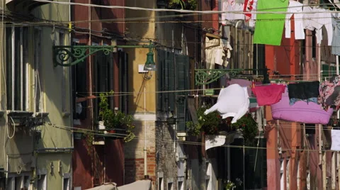 Pulling laundry off the Clothesline in Venice Italy 4K Stock Video Footage Stockbeeldmateriaal 46228854