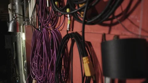 Pulling a microphone cable off of a wall and then placing it back Video stock 89580275