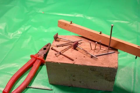 Pulling nails with pliers. Pulling nail with carpenter pliers rescue, assista Stock Photos